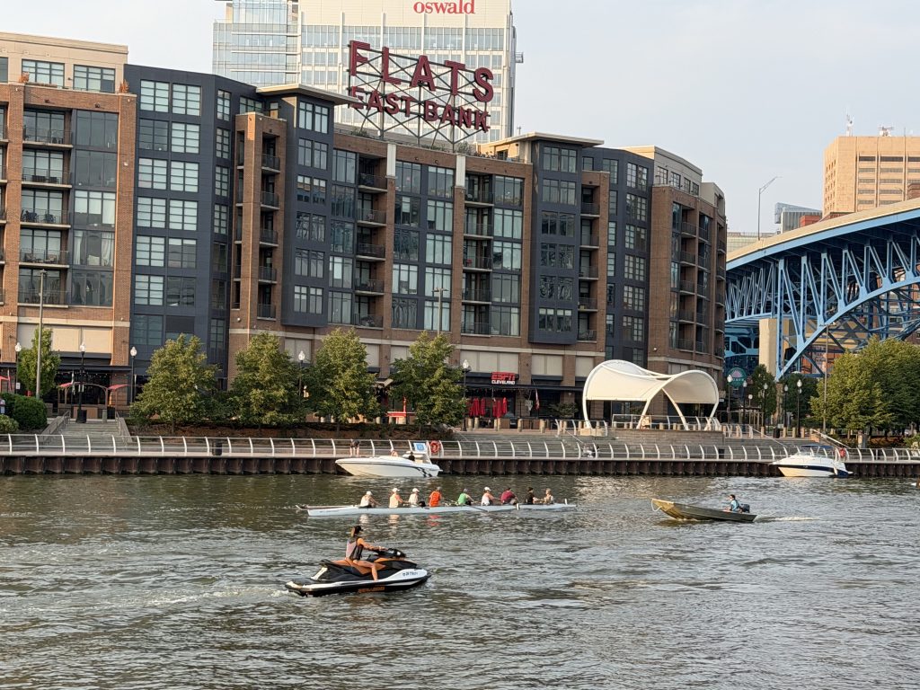 Rowers, Jet Ski and boats on the Cuyahoga River in The Flats in Cleveland