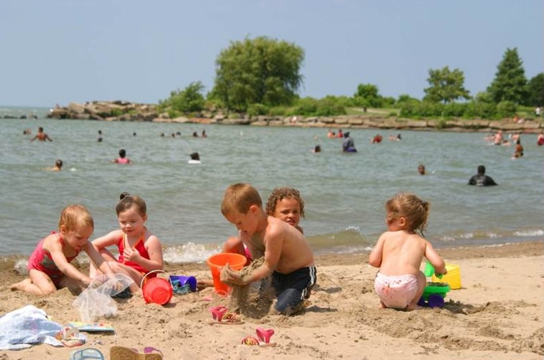 Children playing on the sandy beach at Edgewater Beach in Cleveland