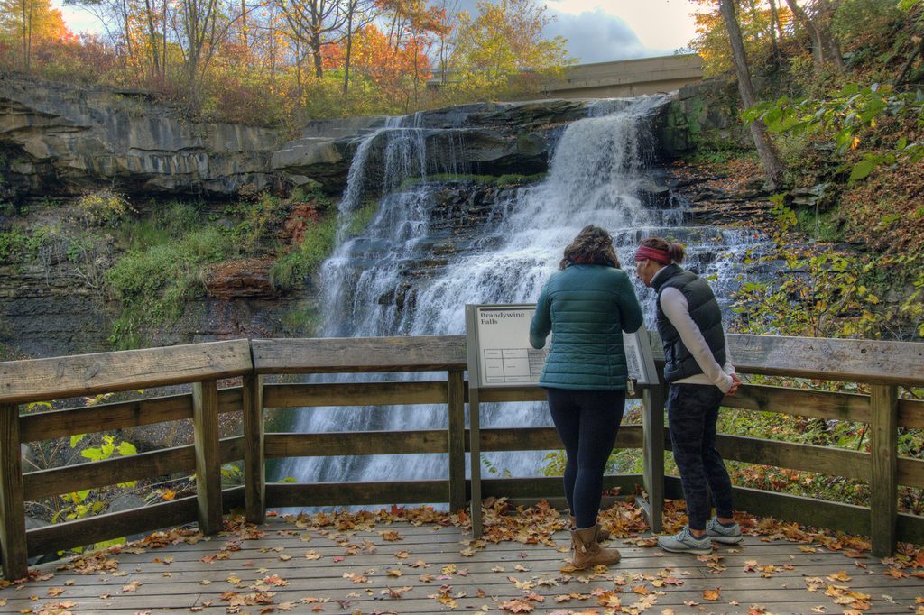 Visitors overlooking Brandywine Falls in Cuyahoga Valley National Park during fall